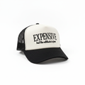 White and black trucker hat with Expensive But The Attitude Is Free embroidered text